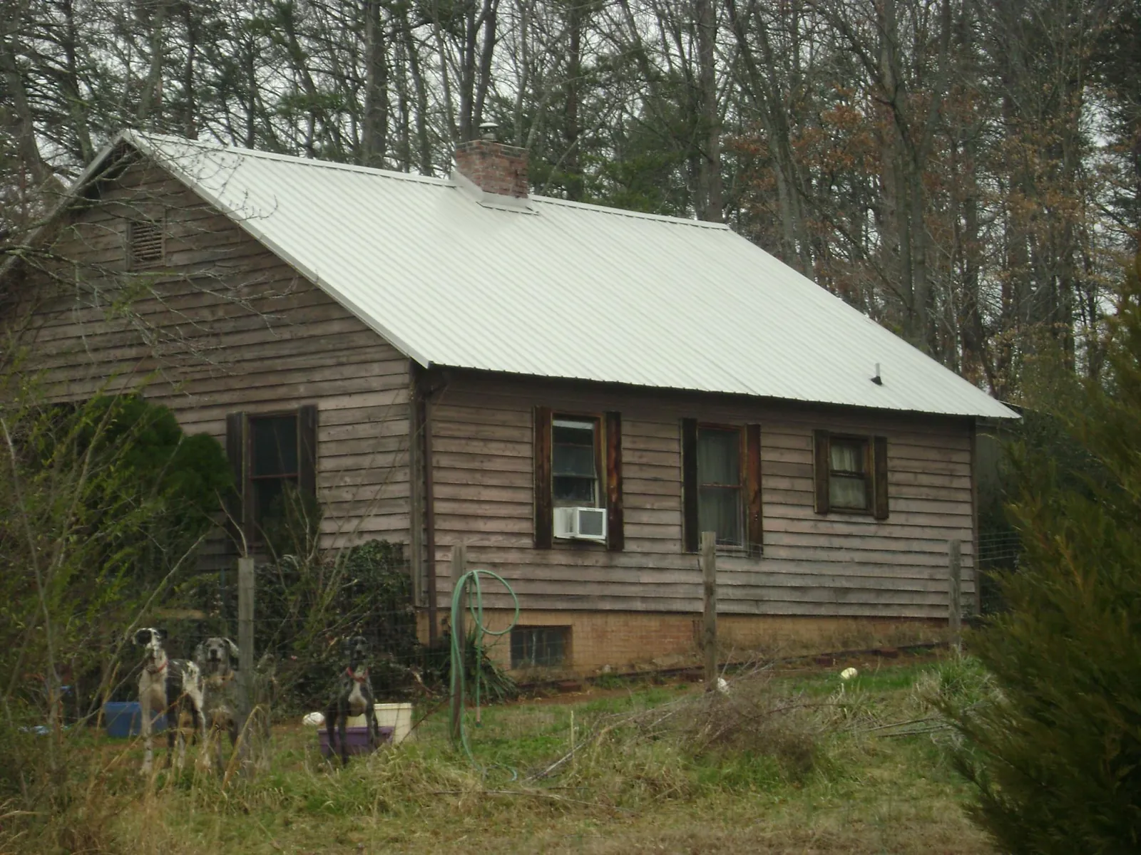 White metal roof on an old wood sided farmhouse, from a Asphalt Shingle Roof Repair job in Gardner